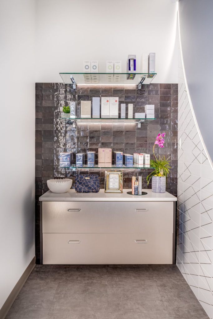 Modern spa display with beauty products and decor.