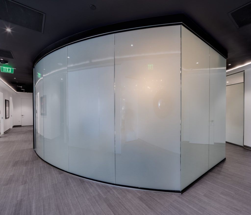 Modern office space with curved glass walls.