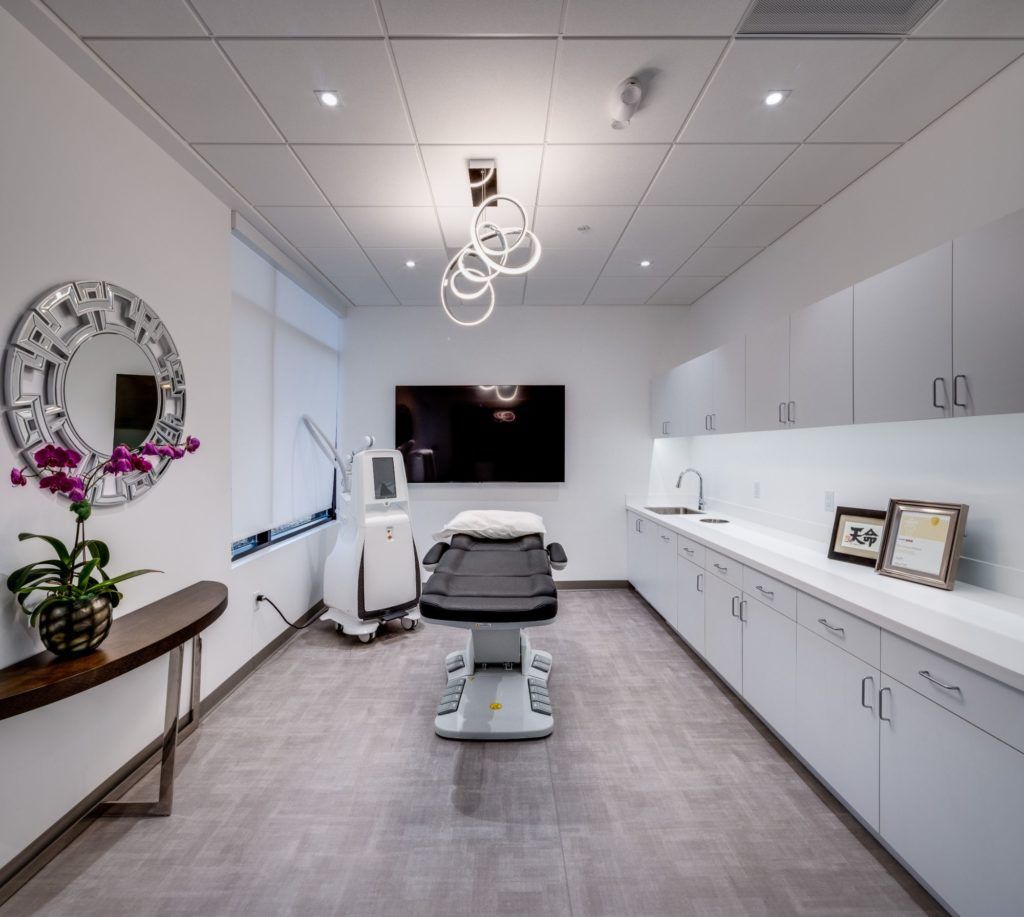 Modern medical office with treatment chair and decor.