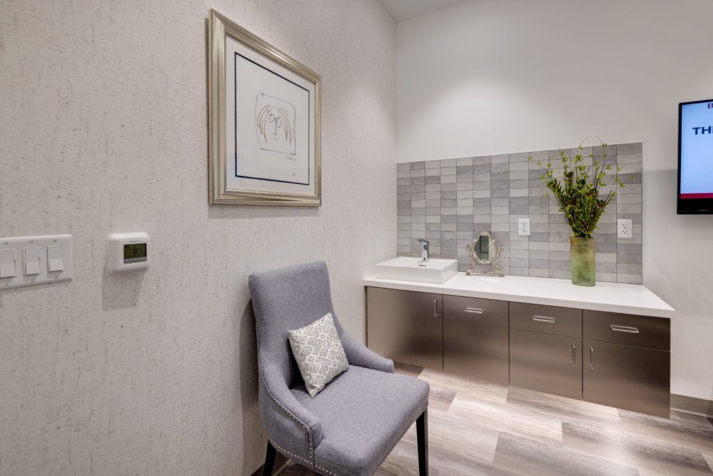 Modern room with chair and decorative accents.