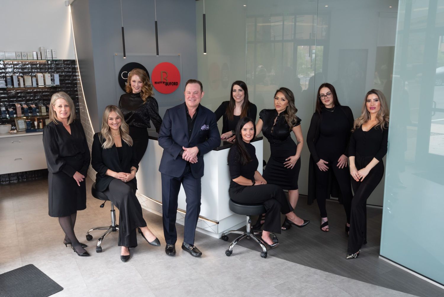Group photo of beauty professionals in salon.