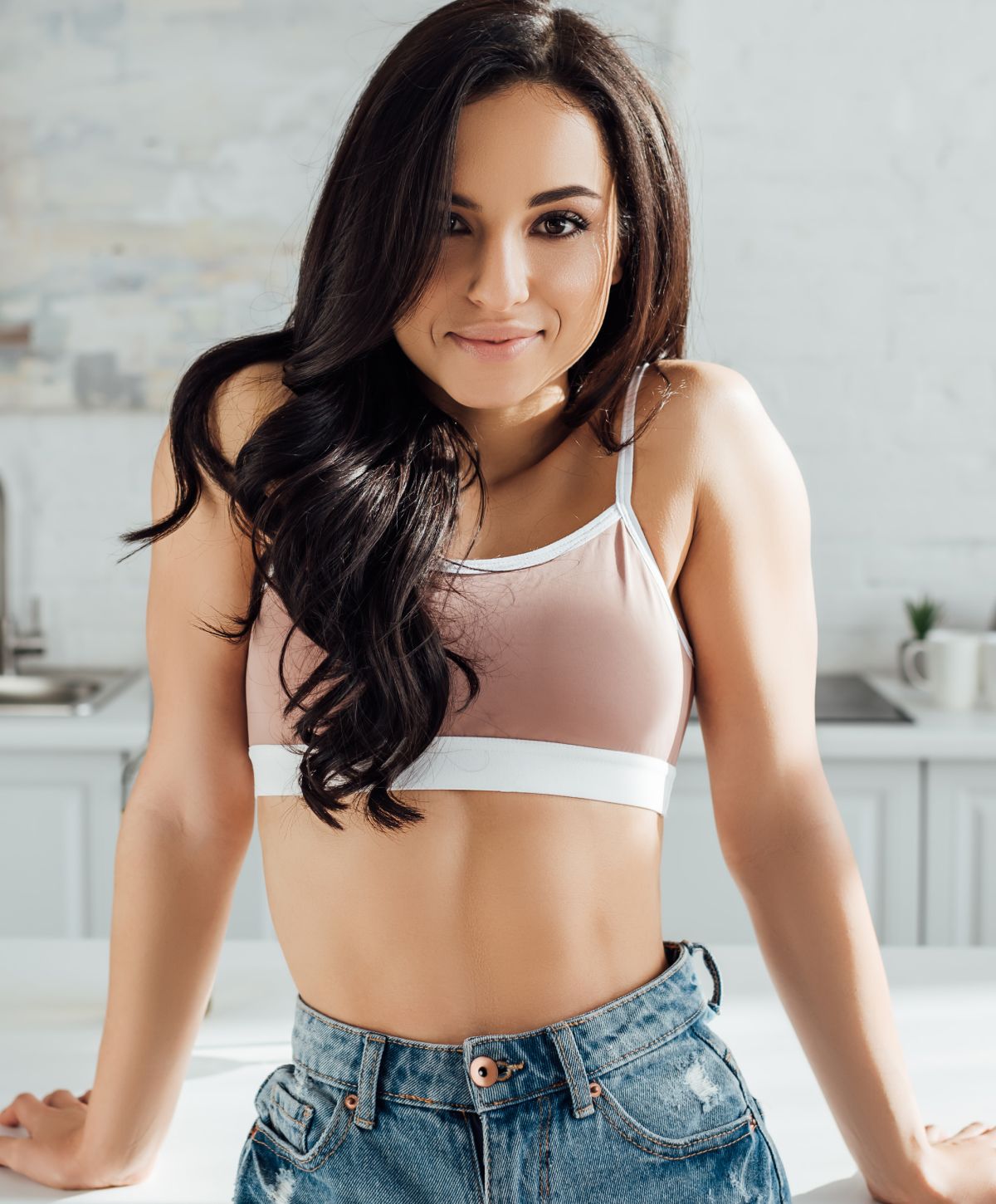 Woman in black bikini and denim jacket.