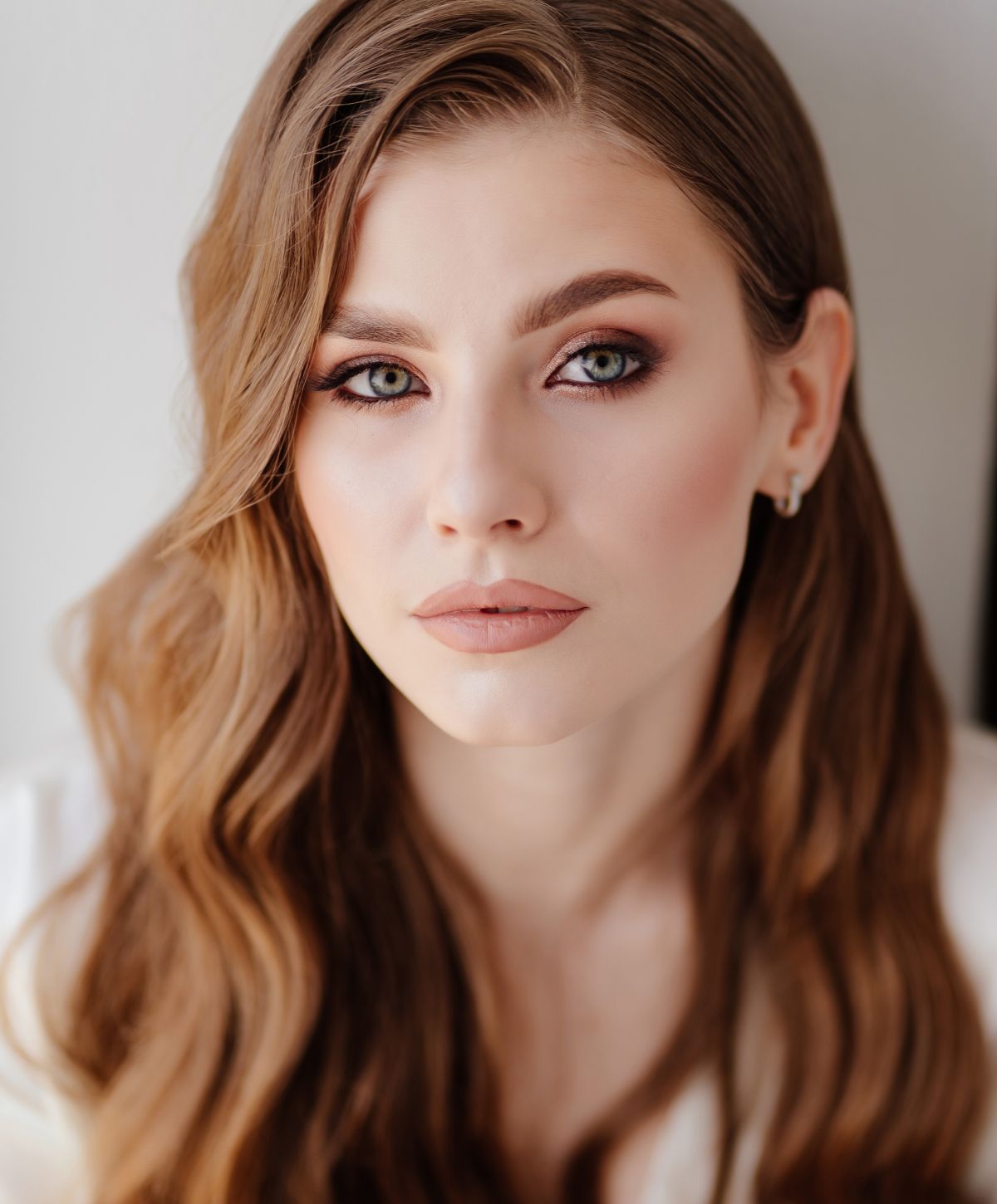 Close-up portrait of a woman with wavy hair.