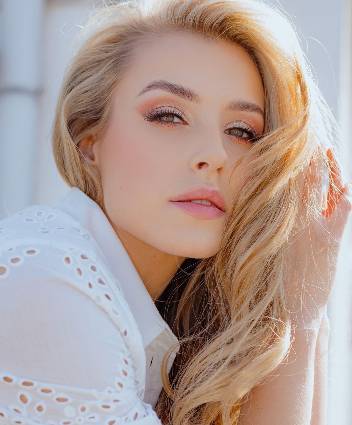 Woman with flowing hair and soft makeup.