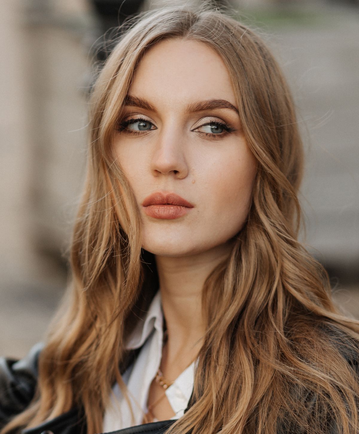 Woman in black bikini and denim jacket.