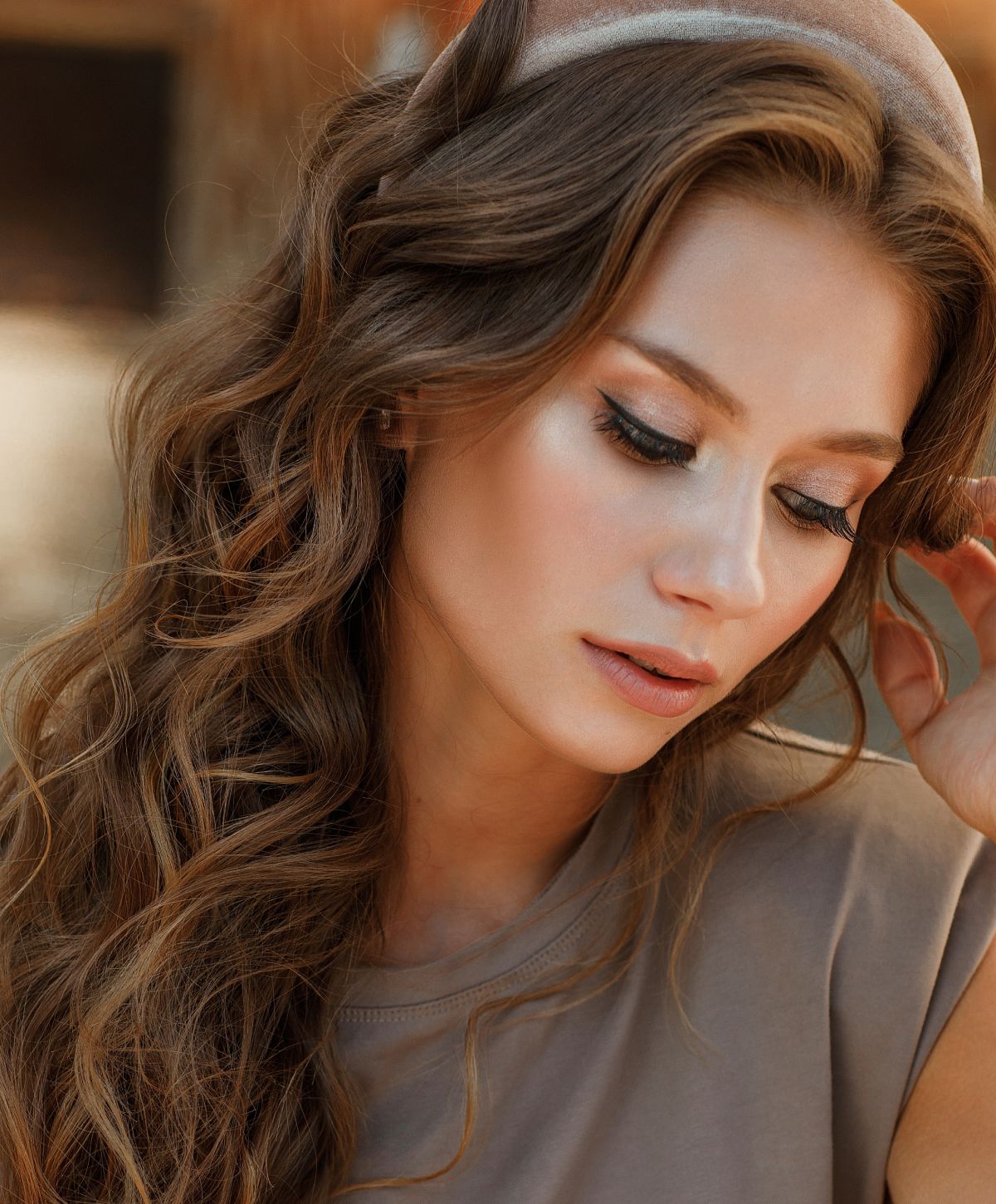 Close-up portrait of a woman with wavy hair.