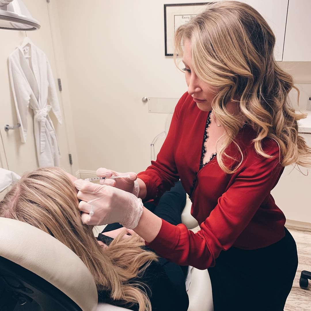 Professional applying cosmetic treatment in clinic setting.