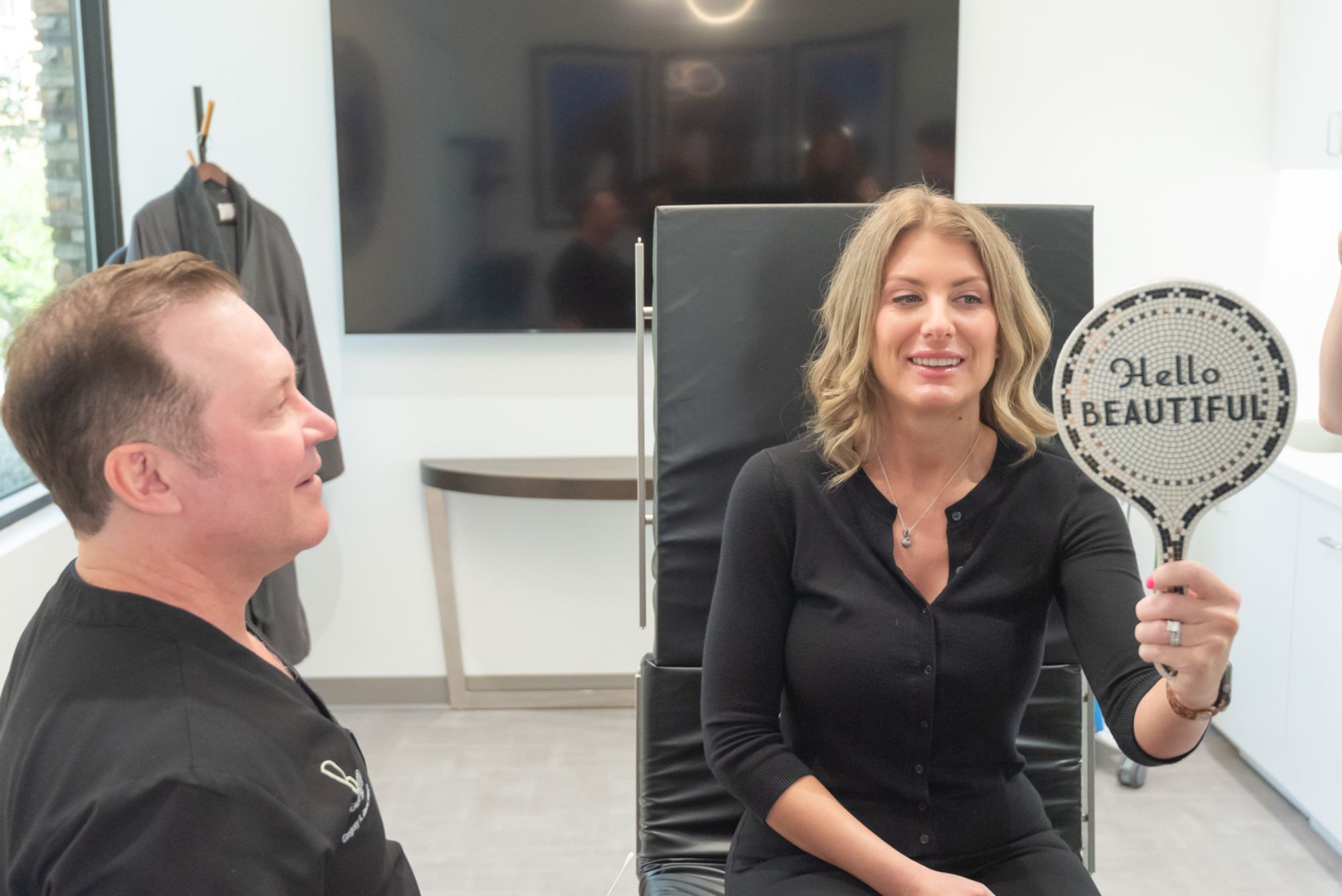 Woman with flowing hair in elegant white outfit.