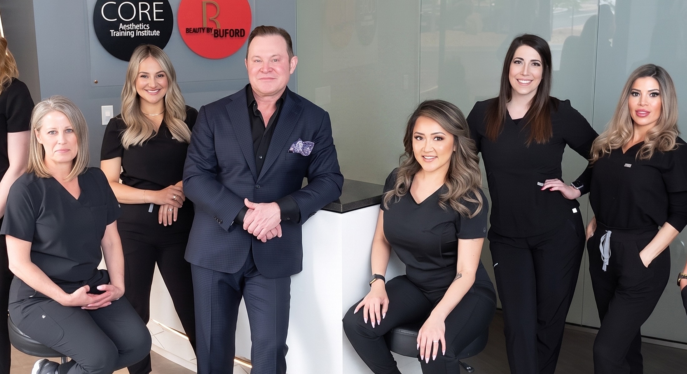 Aesthetic training team in modern clinic setting.